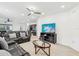 Open-concept living room featuring comfortable seating, a ceiling fan, and a large television at 4324 Desert Rose, Kissimmee, FL 34746