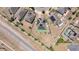 A bird's eye view of a home with solar panels, surrounded by greenery and a fence, showcasing its eco-friendly features at 4804 Marcos Cir, Kissimmee, FL 34758