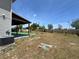 Large backyard offering an outdoor living space, mature trees, and privacy fencing at 4804 Marcos Cir, Kissimmee, FL 34758