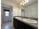 Bathroom featuring a double sink vanity, framed mirror and tile floors at 4804 Marcos Cir, Kissimmee, FL 34758