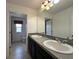 Bathroom with a double sink vanity, framed mirror and tile floors at 4804 Marcos Cir, Kissimmee, FL 34758