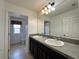 Elegant bathroom featuring a double sink vanity with framed mirror at 4804 Marcos Cir, Kissimmee, FL 34758