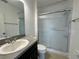 Clean bathroom featuring a single sink vanity and a shower with sliding glass doors at 4804 Marcos Cir, Kissimmee, FL 34758