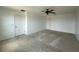Bedroom featuring neutral carpet, two doors and a ceiling fan at 4804 Marcos Cir, Kissimmee, FL 34758