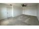 Spacious bedroom featuring neutral carpeting, ceiling fan, and two entry doors at 4804 Marcos Cir, Kissimmee, FL 34758