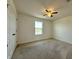 Inviting bedroom boasts carpeted floors, a ceiling fan, and a sun-filled window at 4804 Marcos Cir, Kissimmee, FL 34758