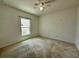 Comfortable bedroom with neutral carpet, ceiling fan, and a bright window for great light at 4804 Marcos Cir, Kissimmee, FL 34758