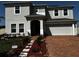 Inviting two-story home showcasing a brick paved driveway and manicured landscaping at 4804 Marcos Cir, Kissimmee, FL 34758