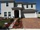 Charming two-story home featuring a brick paved driveway and inviting entrance at 4804 Marcos Cir, Kissimmee, FL 34758