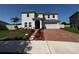 Beautiful two-story home featuring a well-manicured lawn and brick paved driveway at 4804 Marcos Cir, Kissimmee, FL 34758