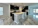 Stylish kitchen featuring dark cabinets, stainless steel appliances, a spacious island and marble flooring at 4804 Marcos Cir, Kissimmee, FL 34758
