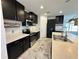Contemporary kitchen with dark cabinets, stainless steel appliances, and a spacious marble floor at 4804 Marcos Cir, Kissimmee, FL 34758