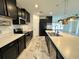 Well-lit kitchen featuring black cabinets, stainless steel appliances, and marble tile flooring at 4804 Marcos Cir, Kissimmee, FL 34758