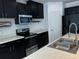 Modern kitchen featuring sleek black cabinetry and stainless steel appliances at 4804 Marcos Cir, Kissimmee, FL 34758