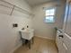Functional laundry room with a utility sink, wire shelving, and ample space at 4804 Marcos Cir, Kissimmee, FL 34758