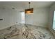 Bright, open-concept living room featuring modern lighting and stylish marble floors at 4804 Marcos Cir, Kissimmee, FL 34758