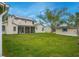 Spacious backyard featuring a well-maintained lawn, mature trees, and a screened-in porch at 483 Stillwater Dr, Oviedo, FL 32765