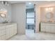 Modern bathroom featuring dual sinks, marble floors, and a walk-in shower at 483 Stillwater Dr, Oviedo, FL 32765