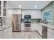 Bright eat-in kitchen featuring white cabinets, granite counters, and stainless appliances at 483 Stillwater Dr, Oviedo, FL 32765