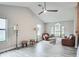 Bright living room features vaulted ceiling, wood-look floors, and large windows at 483 Stillwater Dr, Oviedo, FL 32765