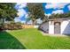 Large, grassy backyard with privacy fence and mature trees at 502 Engel Dr, Orlando, FL 32807