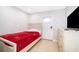 Clean bedroom featuring tile floors, a white door, and a bed with red blanket at 502 Engel Dr, Orlando, FL 32807