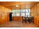 Cozy dining area features wood-paneled walls, laminate flooring, and windows offering natural light at 502 Engel Dr, Orlando, FL 32807