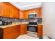 Well-organized kitchen featuring stainless steel appliances and granite countertops at 502 Engel Dr, Orlando, FL 32807