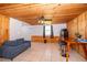 Open living room features a wooden ceiling, and wood paneling and tile flooring at 502 Engel Dr, Orlando, FL 32807