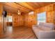 Living room features a wooden ceiling, wood paneling, and laminate flooring at 502 Engel Dr, Orlando, FL 32807