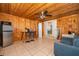 Open living room features a wooden ceiling, and wood paneling and tile flooring at 502 Engel Dr, Orlando, FL 32807