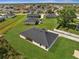 Aerial view of the home showing the dark roof, surrounding neighborhood, and expansive green lawn at 502 Viceroy Ct, Kissimmee, FL 34758