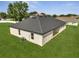 Aerial view of the home's backyard with a dark roof and manicured lawn at 502 Viceroy Ct, Kissimmee, FL 34758