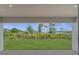 A beautiful backyard view from a covered patio shows a well-maintained lawn and lush trees at 502 Viceroy Ct, Kissimmee, FL 34758