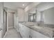 This primary bathroom features double sinks, stone countertops and walk-in glass shower at 502 Viceroy Ct, Kissimmee, FL 34758