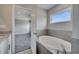 This bathroom features a luxurious soaking tub, tiled backsplash and granite countertops at 502 Viceroy Ct, Kissimmee, FL 34758