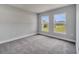 Bright bedroom showcasing two windows with views of the landscape and neutral-toned carpeting at 502 Viceroy Ct, Kissimmee, FL 34758