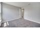 Bedroom with neutral walls and carpet features an open doorway and calming natural light at 502 Viceroy Ct, Kissimmee, FL 34758