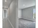 Hallway view of a bedroom with neutral walls and carpet with a closet and a bright window at 502 Viceroy Ct, Kissimmee, FL 34758