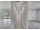 This tiled hallway leads to the main living area and bedrooms with neutral gray paint at 502 Viceroy Ct, Kissimmee, FL 34758