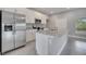 Open kitchen with stainless steel appliances, white cabinets, and granite countertops on the island at 502 Viceroy Ct, Kissimmee, FL 34758