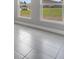 Bright living area featuring a window with trim, tile flooring, and painted walls at 502 Viceroy Ct, Kissimmee, FL 34758