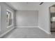 Well-lit room with tile flooring, a window, and a seamless transition to the kitchen at 502 Viceroy Ct, Kissimmee, FL 34758