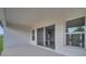 A covered patio features neutral colors and sliding glass doors leading to the interior of the home at 502 Viceroy Ct, Kissimmee, FL 34758