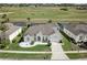 Aerial view of a home overlooking a golf course, featuring a well-manicured lawn at 520 Prestwick Dr, Davenport, FL 33897