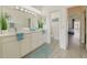 Bright bathroom features double vanity, large mirror, and a separate toilet area for added privacy and convenience at 520 Prestwick Dr, Davenport, FL 33897
