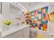 Bright bathroom features a colorful Lego themed shower curtain and a vanity with a large mirror at 520 Prestwick Dr, Davenport, FL 33897