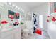 Bright bathroom with Mickey Mouse themed decor, white vanity, and shower with patterned curtain at 520 Prestwick Dr, Davenport, FL 33897