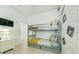 Charming bedroom featuring bunk beds, neutral decor, and a TV on the wall at 520 Prestwick Dr, Davenport, FL 33897