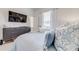 Comfortable bedroom with modern dresser, TV, and bright window allowing lots of natural light at 520 Prestwick Dr, Davenport, FL 33897